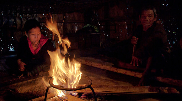 Nyishi man and woman at fireplace